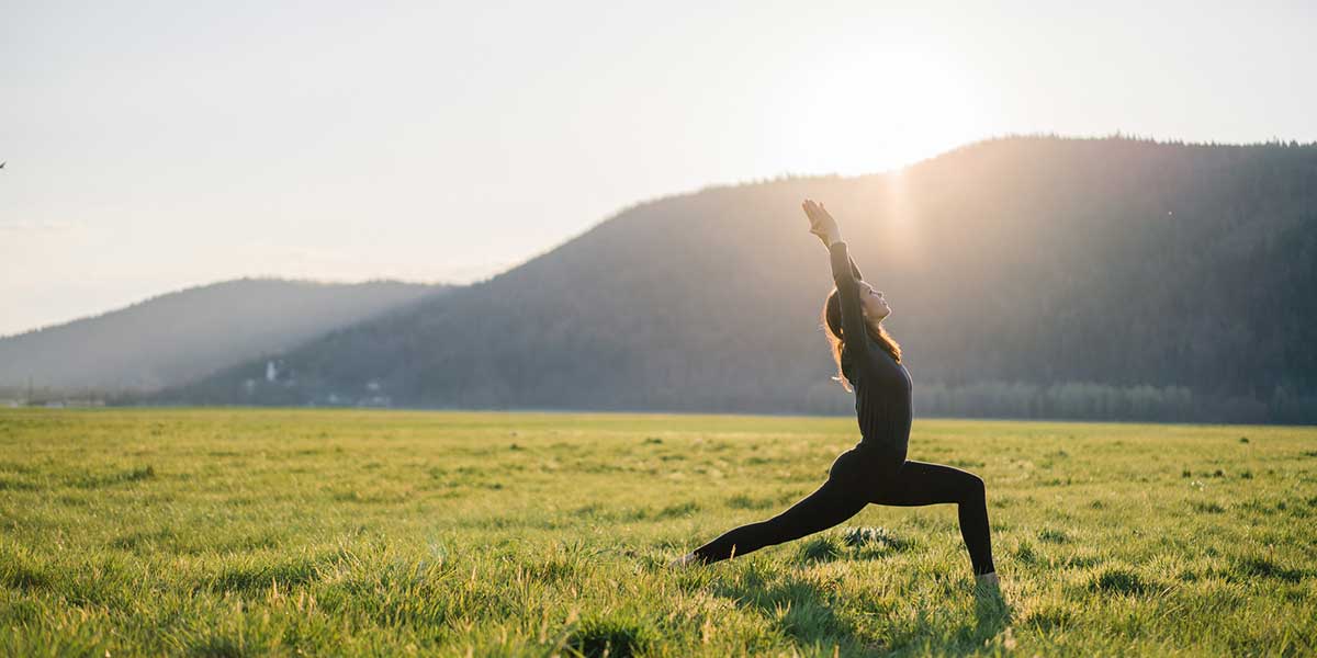 person doing yoga in a field