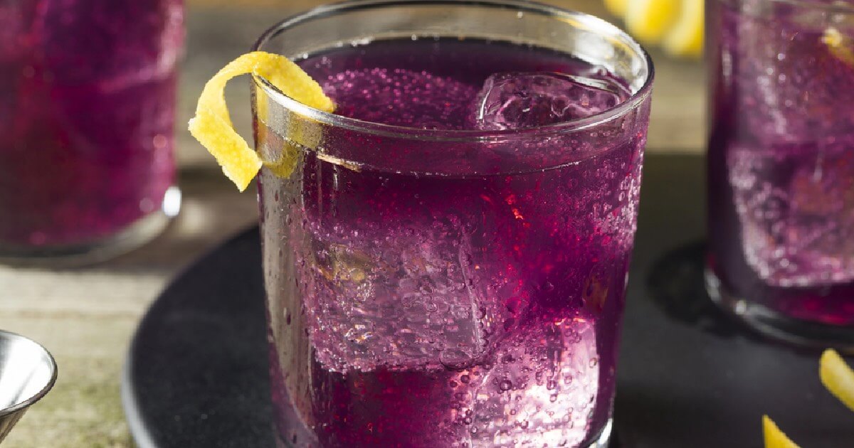 A refreshing purple beverage featuring ice and lemon slices, commonly linked to lean drinks and their addictive nature.